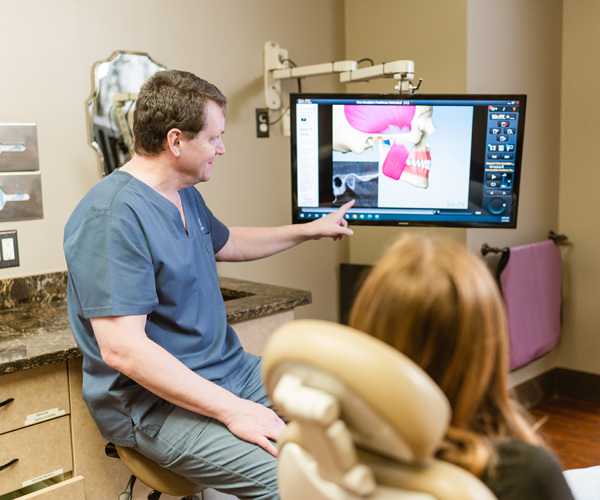 Dr. Baier reviewing digital dental images with a patient